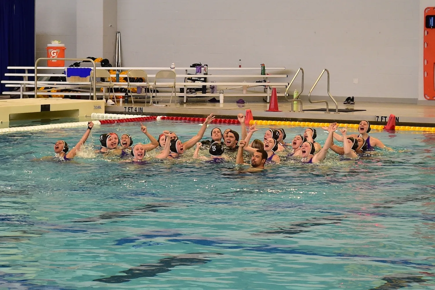 McKendree University's women's water polo team celebrates with its coaches.
